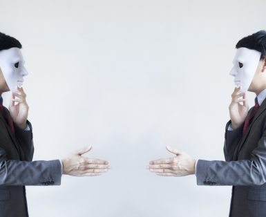 Two men in business suit handshaking with masks on