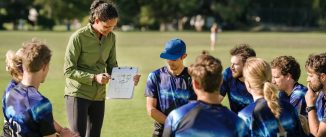 Shot of a football coach coaching a team before the game