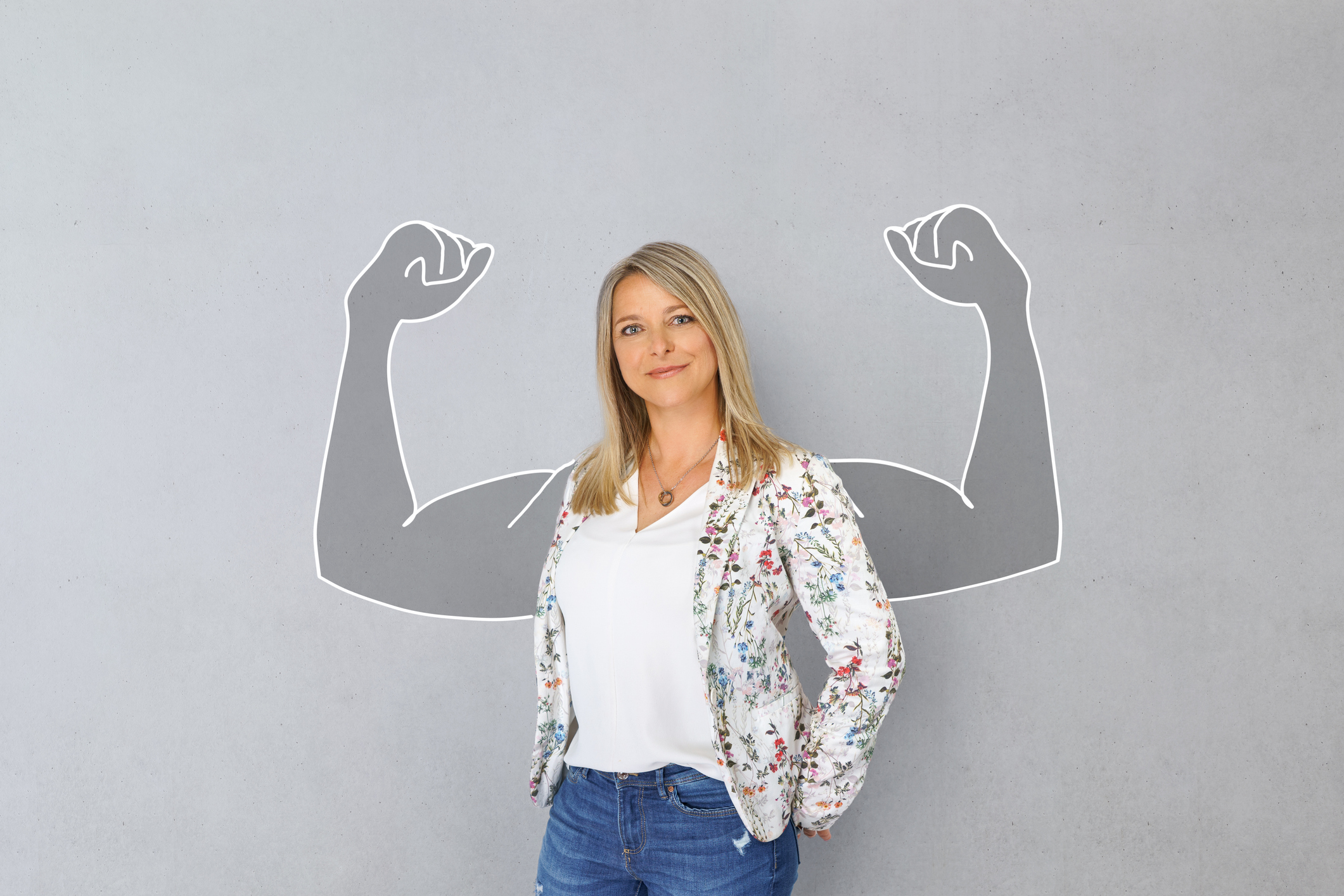 40 year old happy and successful woman with muscular arms drawn around her shoulders