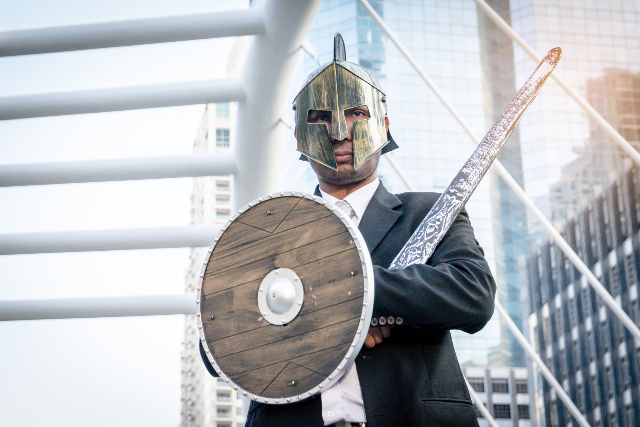 Knight businessman wearing an helm and steel sword.