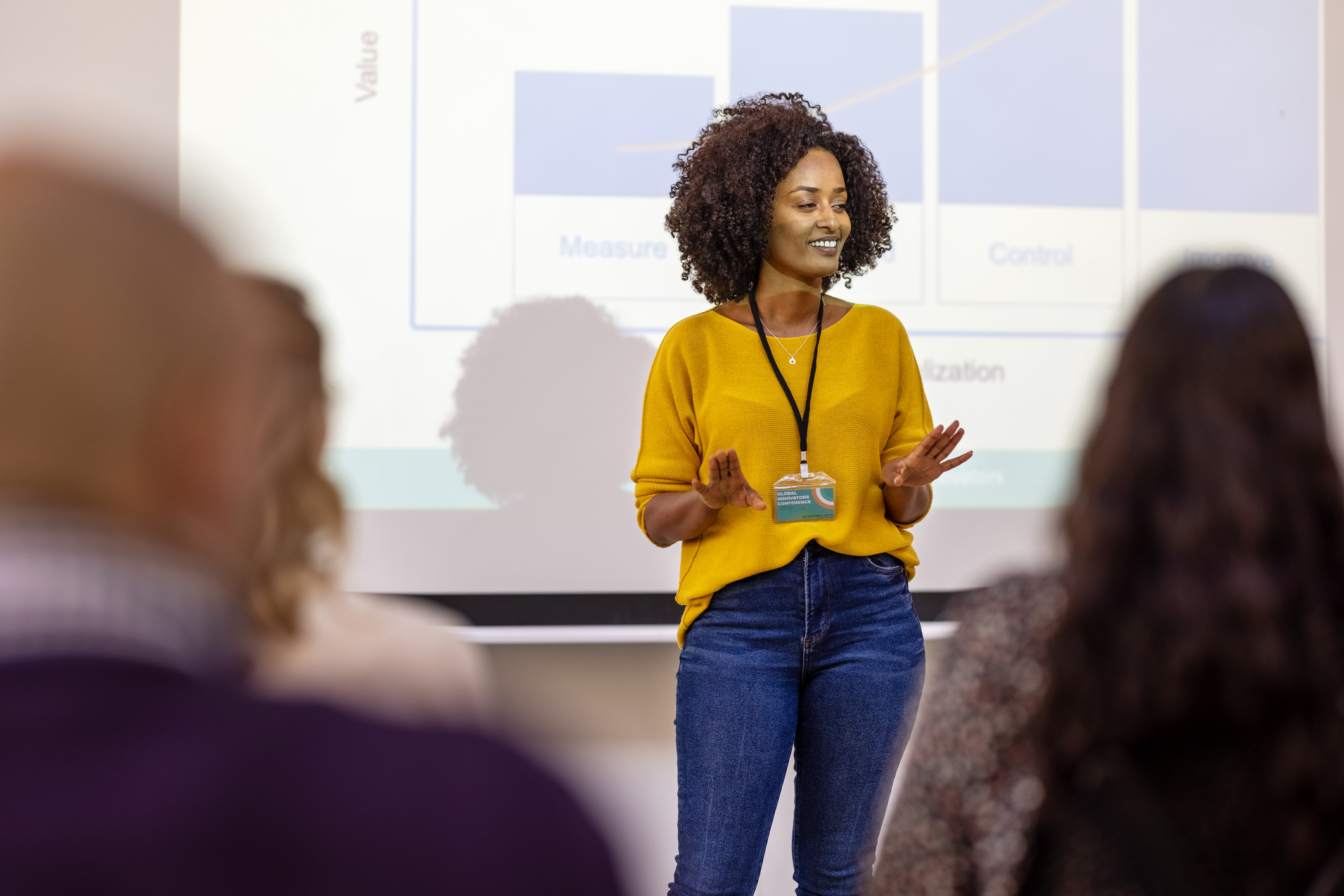 African businesswoman sharing statistics and growth rate during a conference. Female entrepreneur presenting at business seminar.