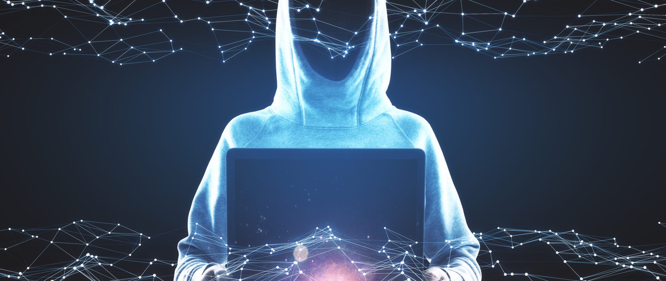 Hacker in hoodie using laptop with glowing polygonal hologram on dark background. Innovation, ai and hacking concept. Multiexposure