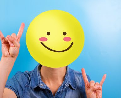 Unrecognizable woman with happy smiley instead of face