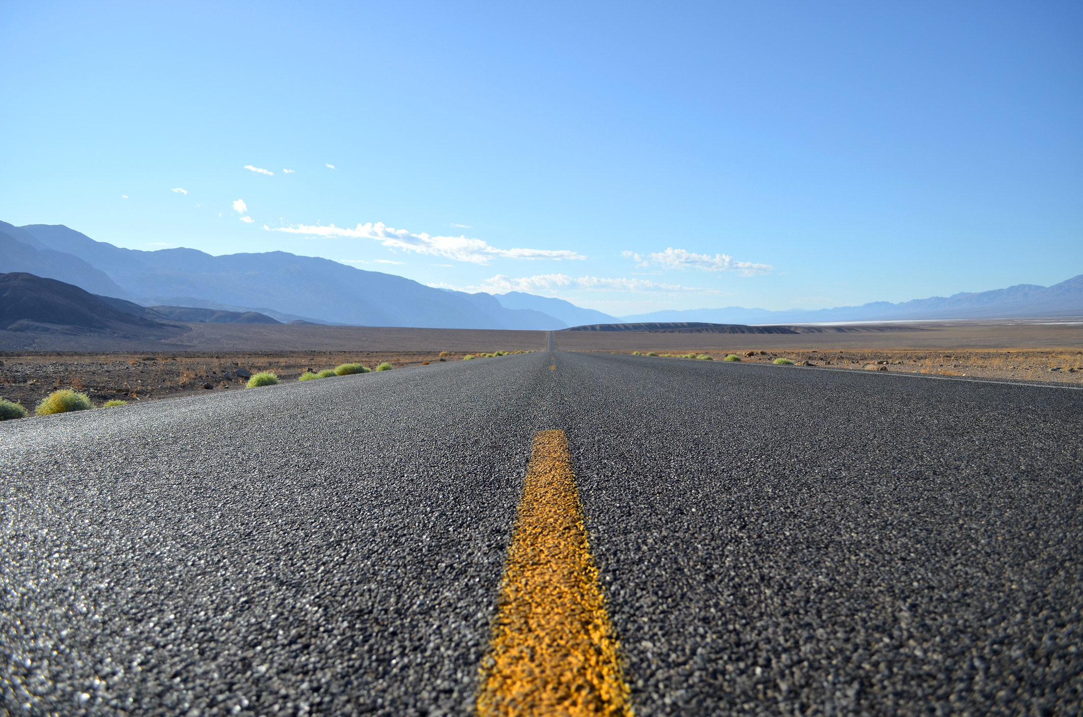 photograph with point of view asphalt height of the road that crosses the Death Valley in California in the United States of America and that seems to never end.